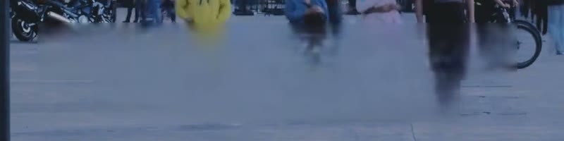 100% crop showing ghosting where pedestrians crossed behind a caption
